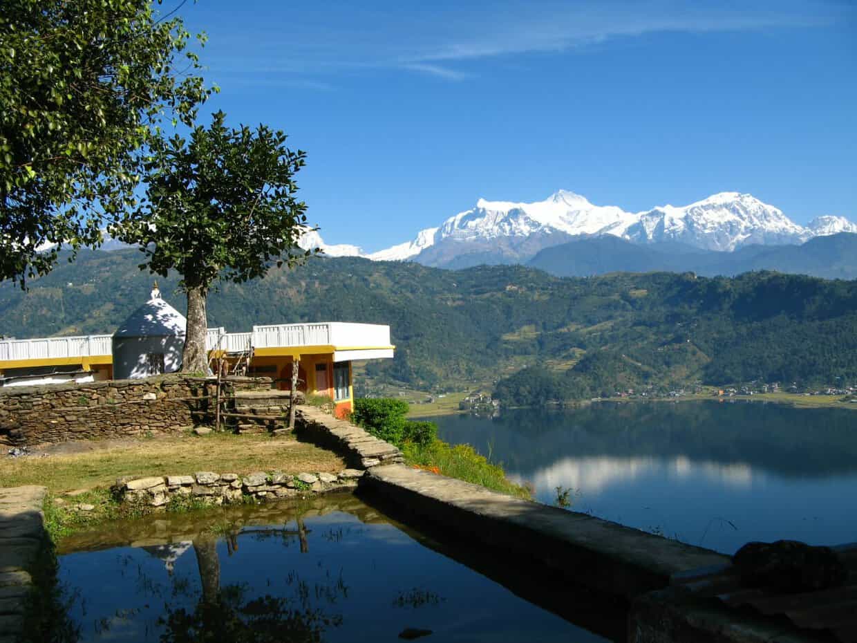 Pokhara landscape with lake, temple, and snow-capped Annapurna mountains in Nepal
