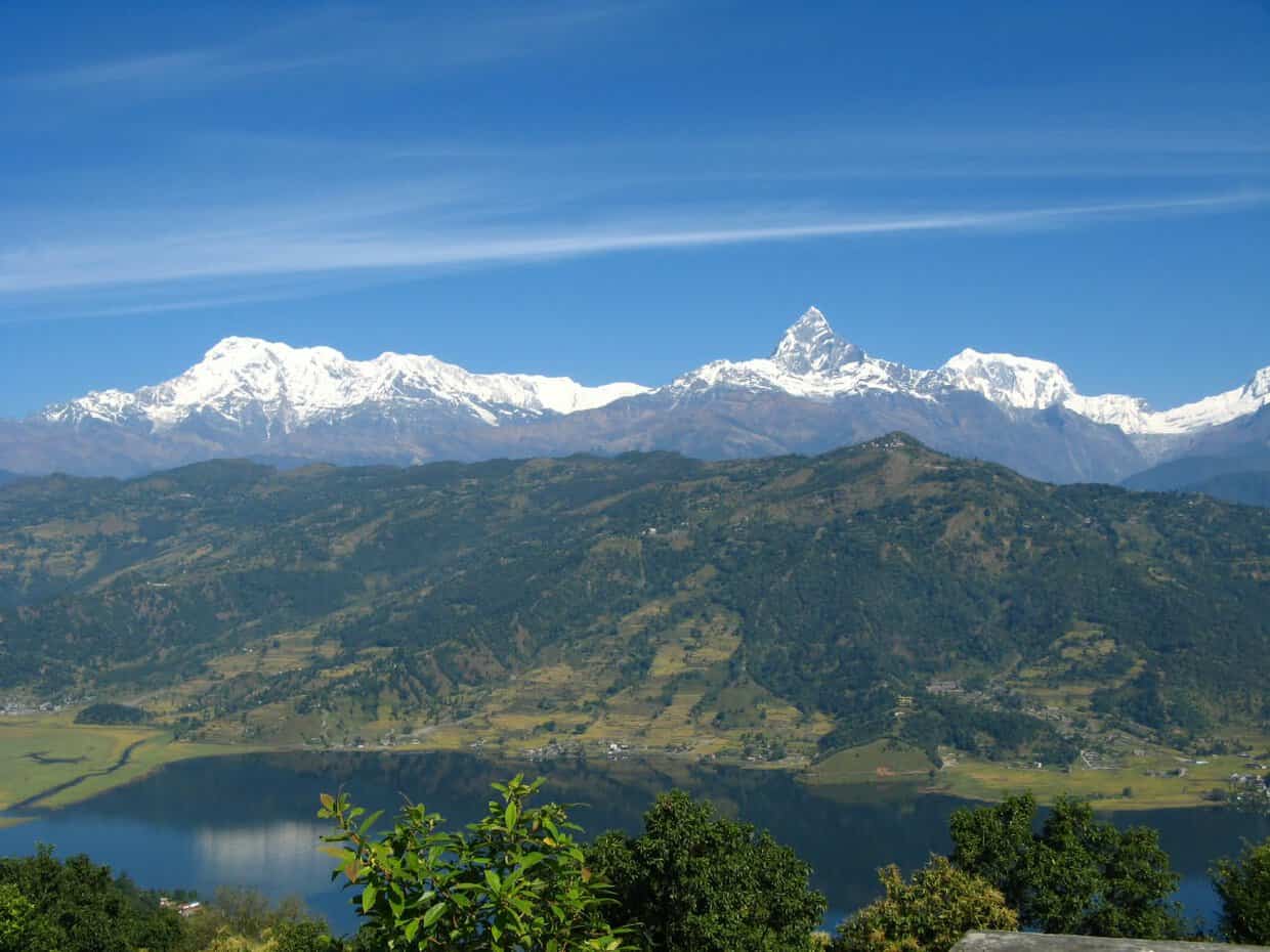 Annapurna mountain range and Machhapuchhre peak reflected in Phewa Lake near Pokhara, Nepal